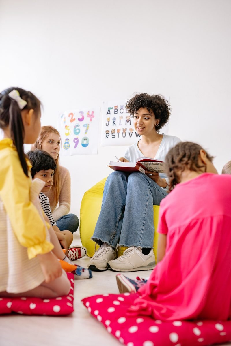 Teacher reading a story to preschool children during circle time